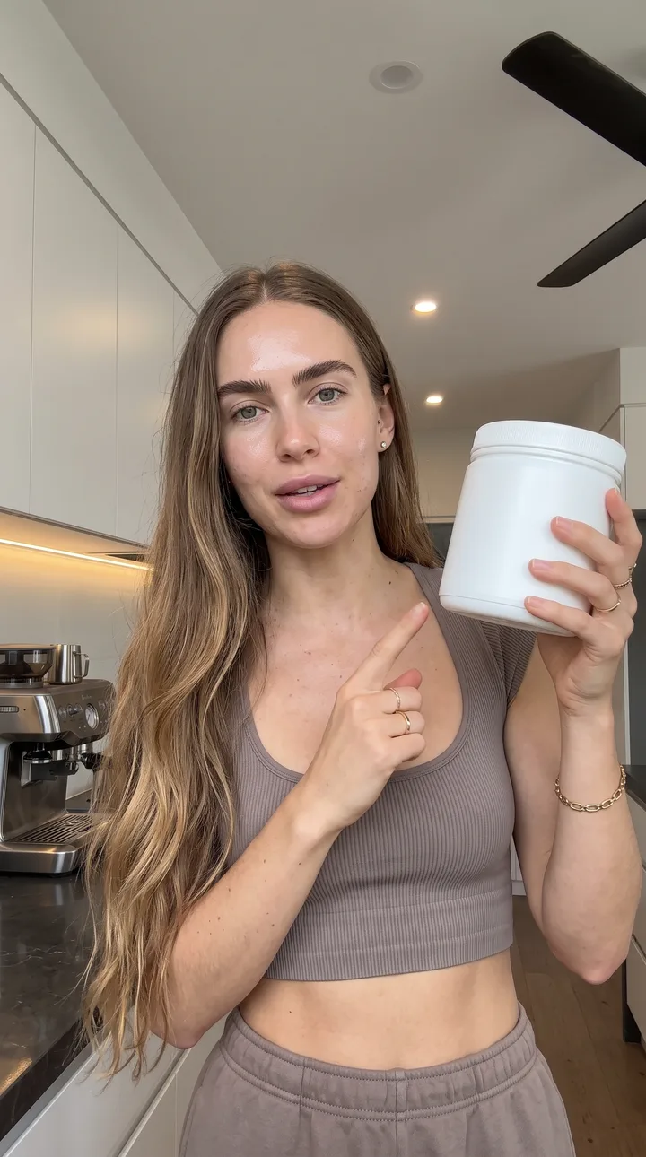 Wellness AI UGC ad still: Supplement routine. Tub raised, label held to lens.